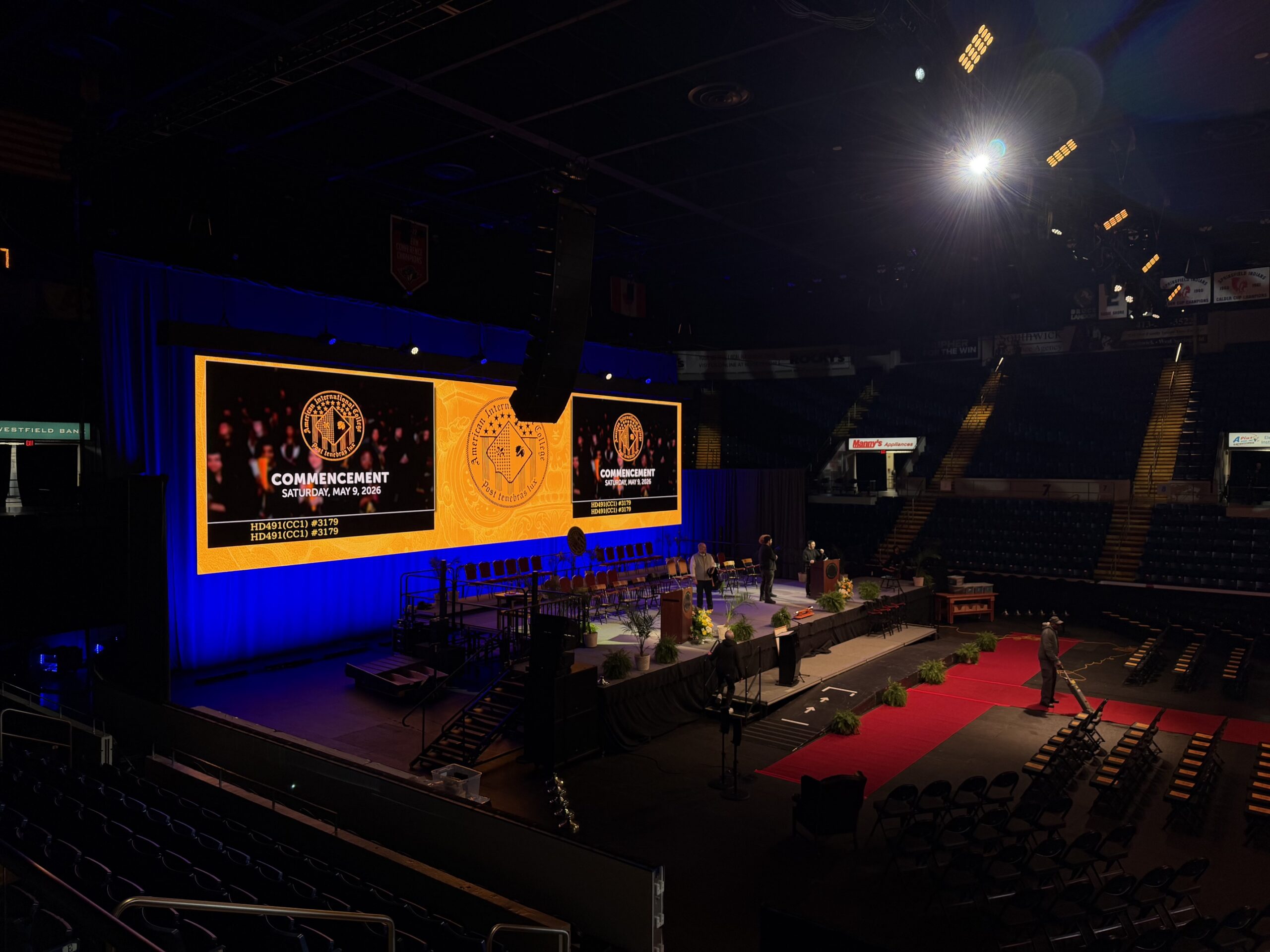 Commencement stage with large widescreen LED video wall and event lighting