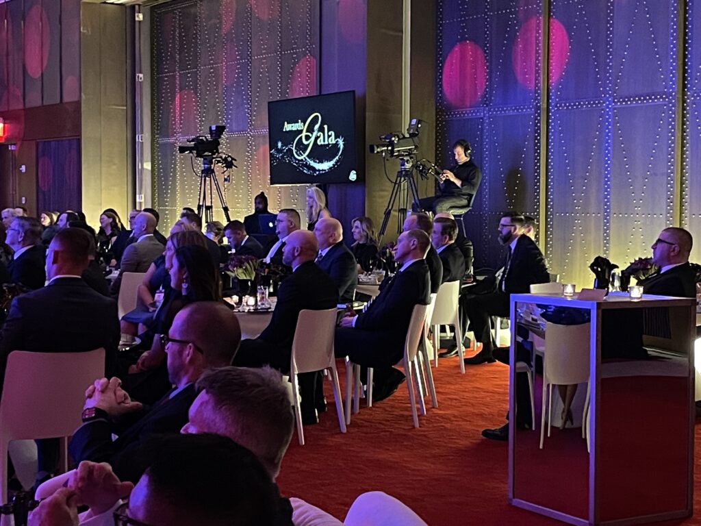 Camera positions and audience during the confidential global biotech annual meeting at the TWA Hotel.