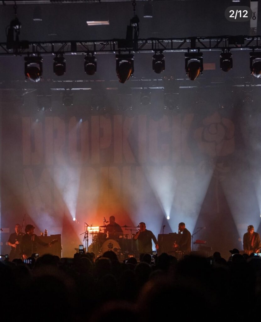 Wide view of concert stage lighting and audience at MassMutual Center.