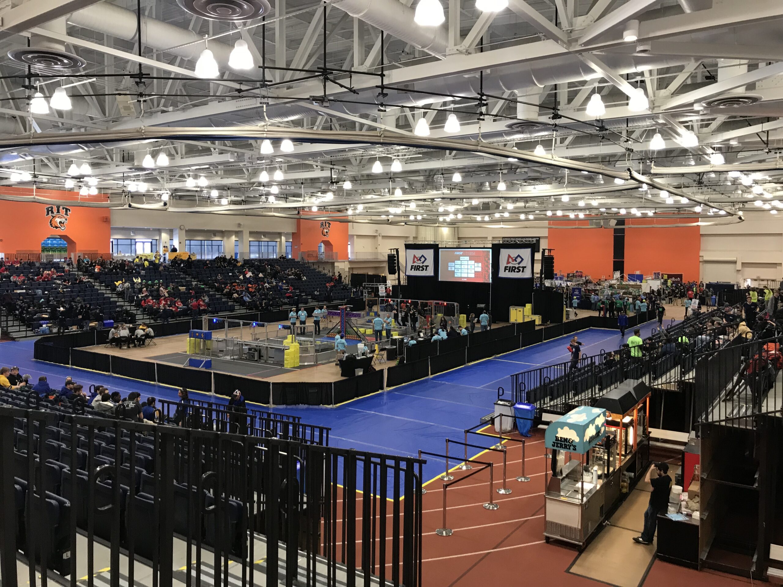 Wide view of the FIRST Robotics Competition Finger Lakes Regional competition arena at Rochester Institute of Technology in 2018.