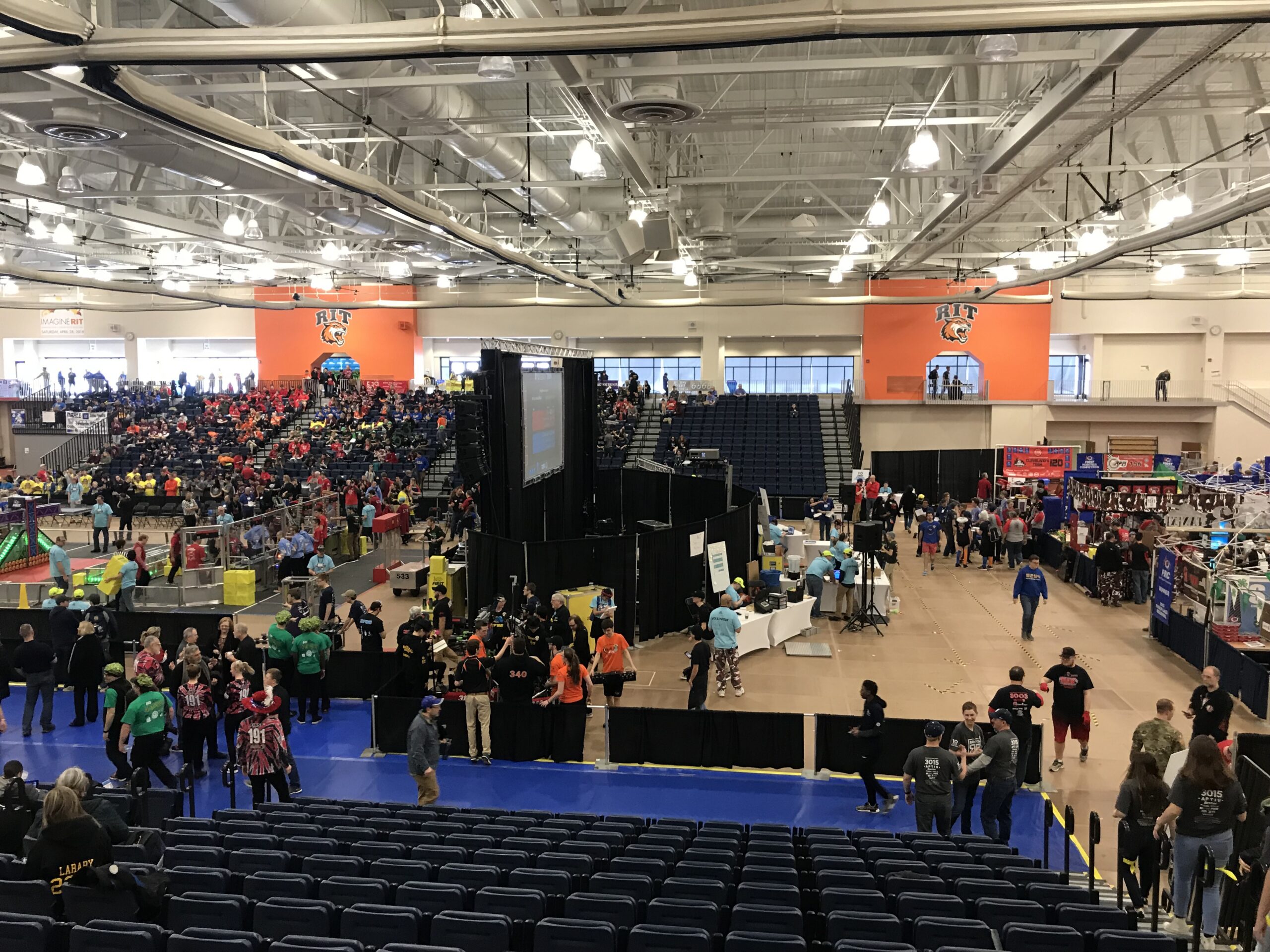Packed arena during the 2018 FIRST Robotics Competition Finger Lakes Regional at RIT, with the competition field, audience and production systems visible.