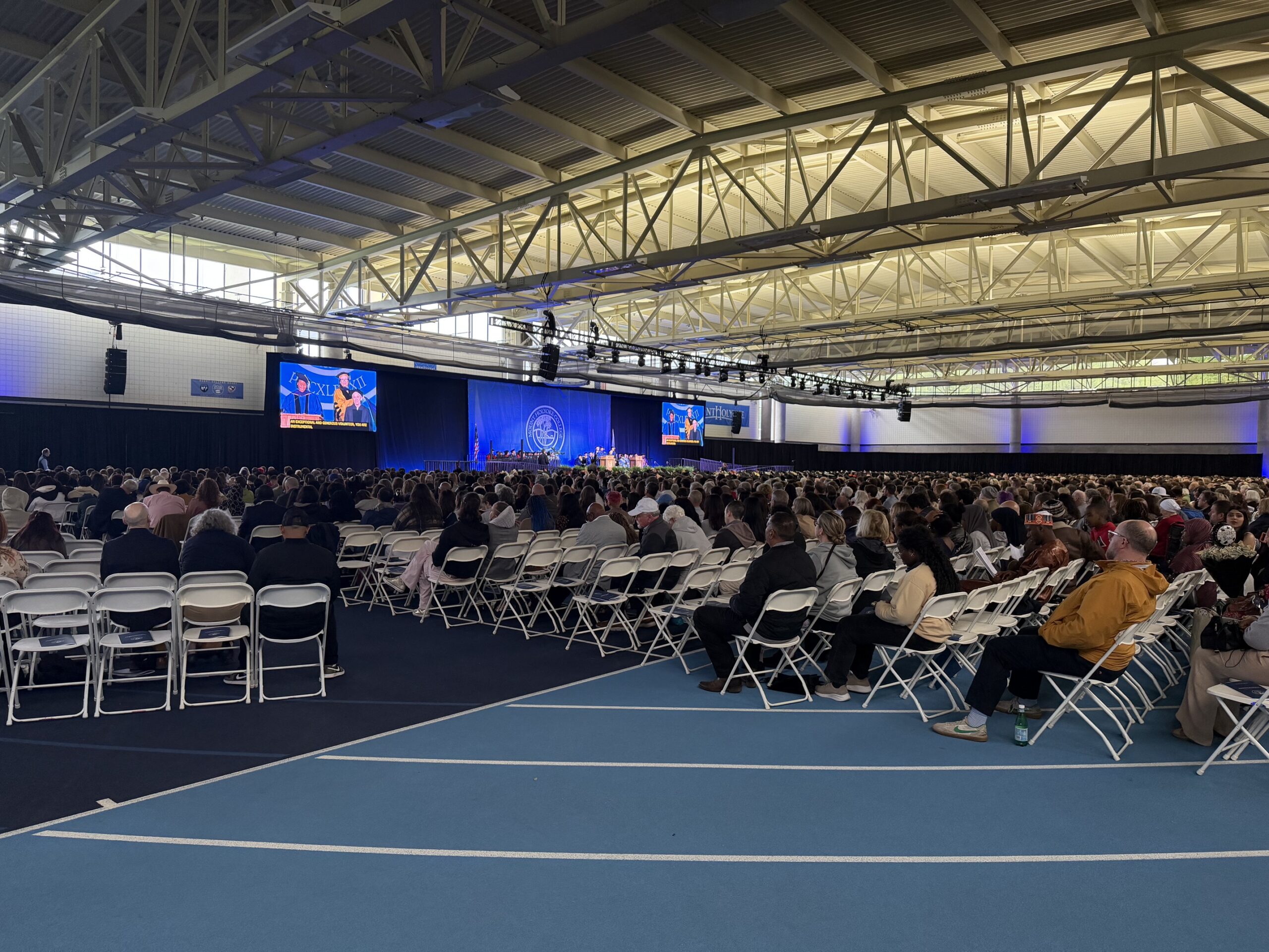 Professional camera operator capturing commencement IMAG for a large audience